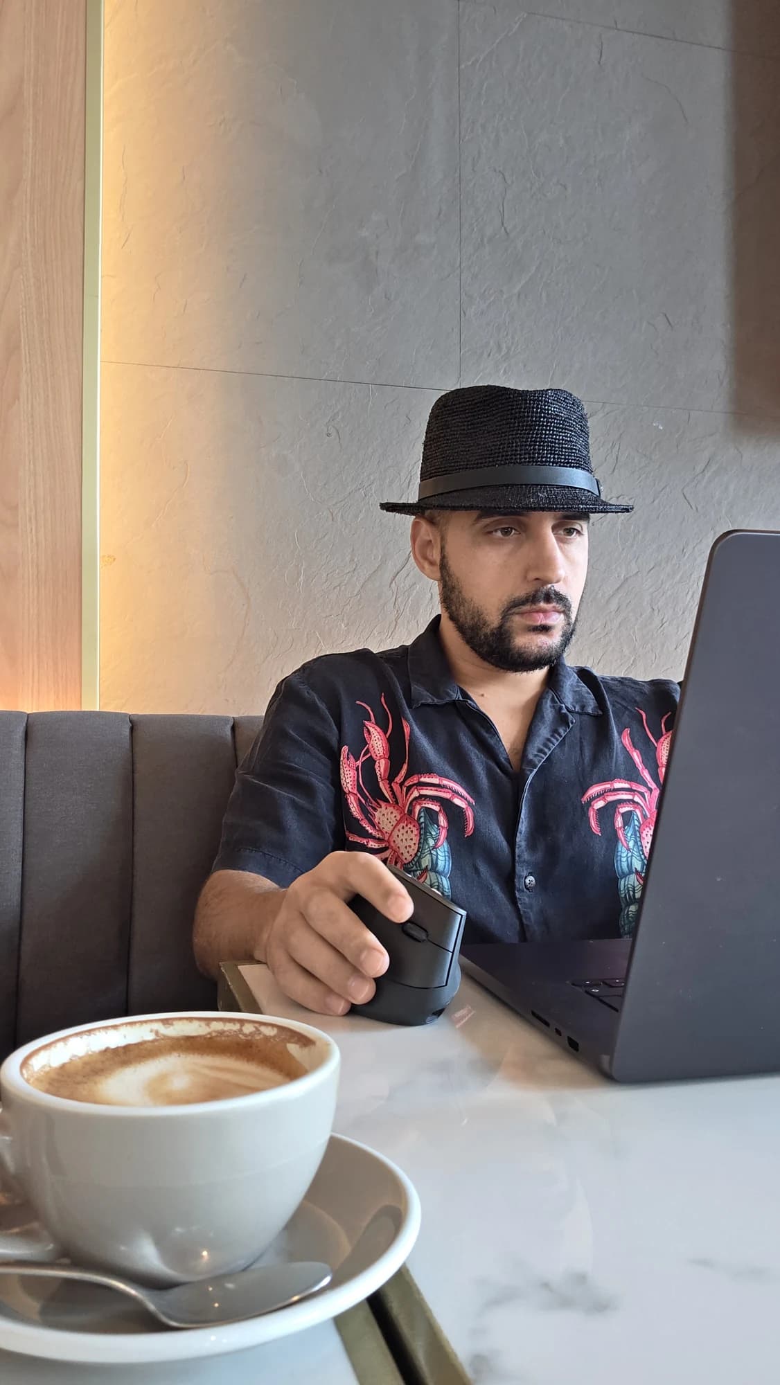 Rachid working on his laptop in Asia